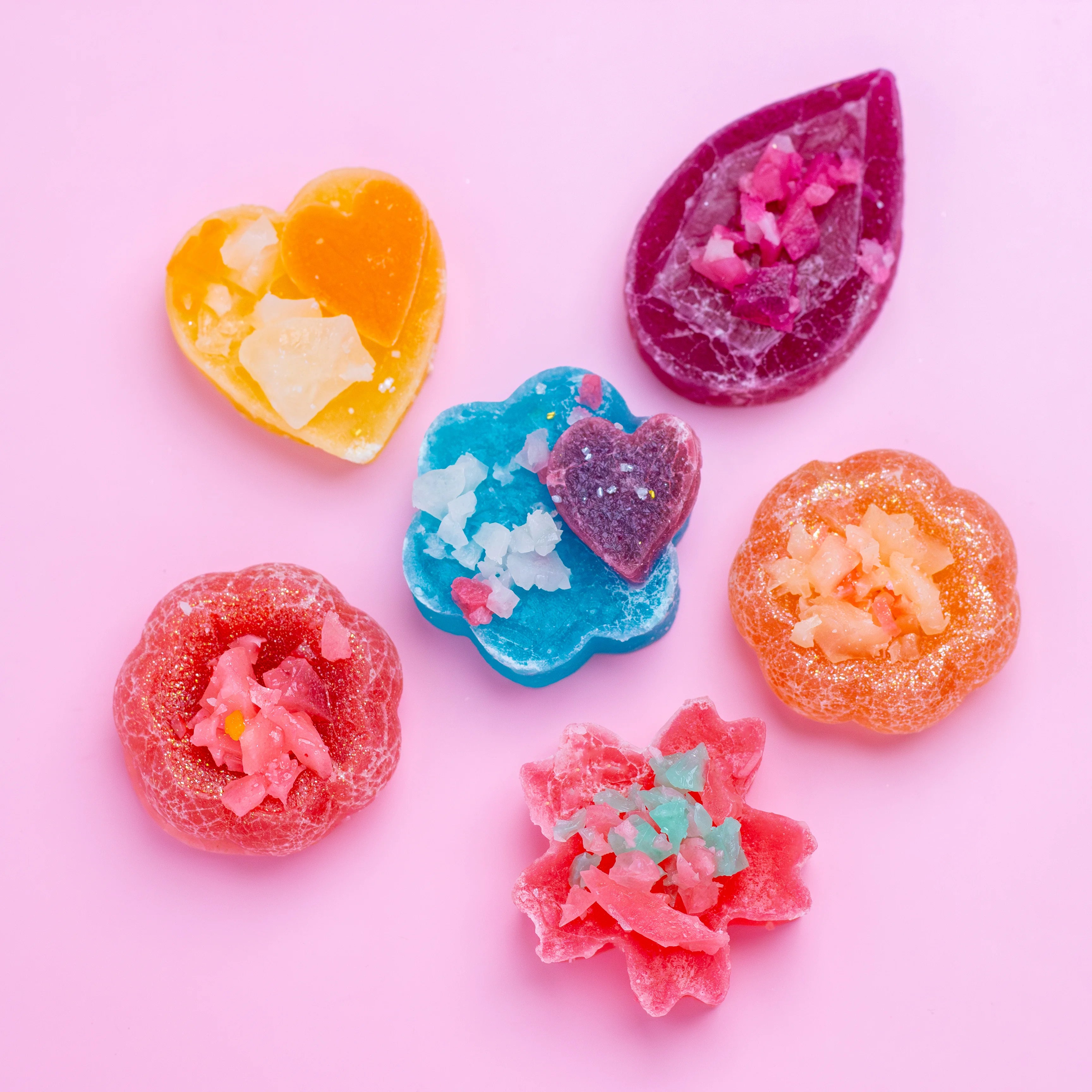 Colorful gummy candies on a pink background