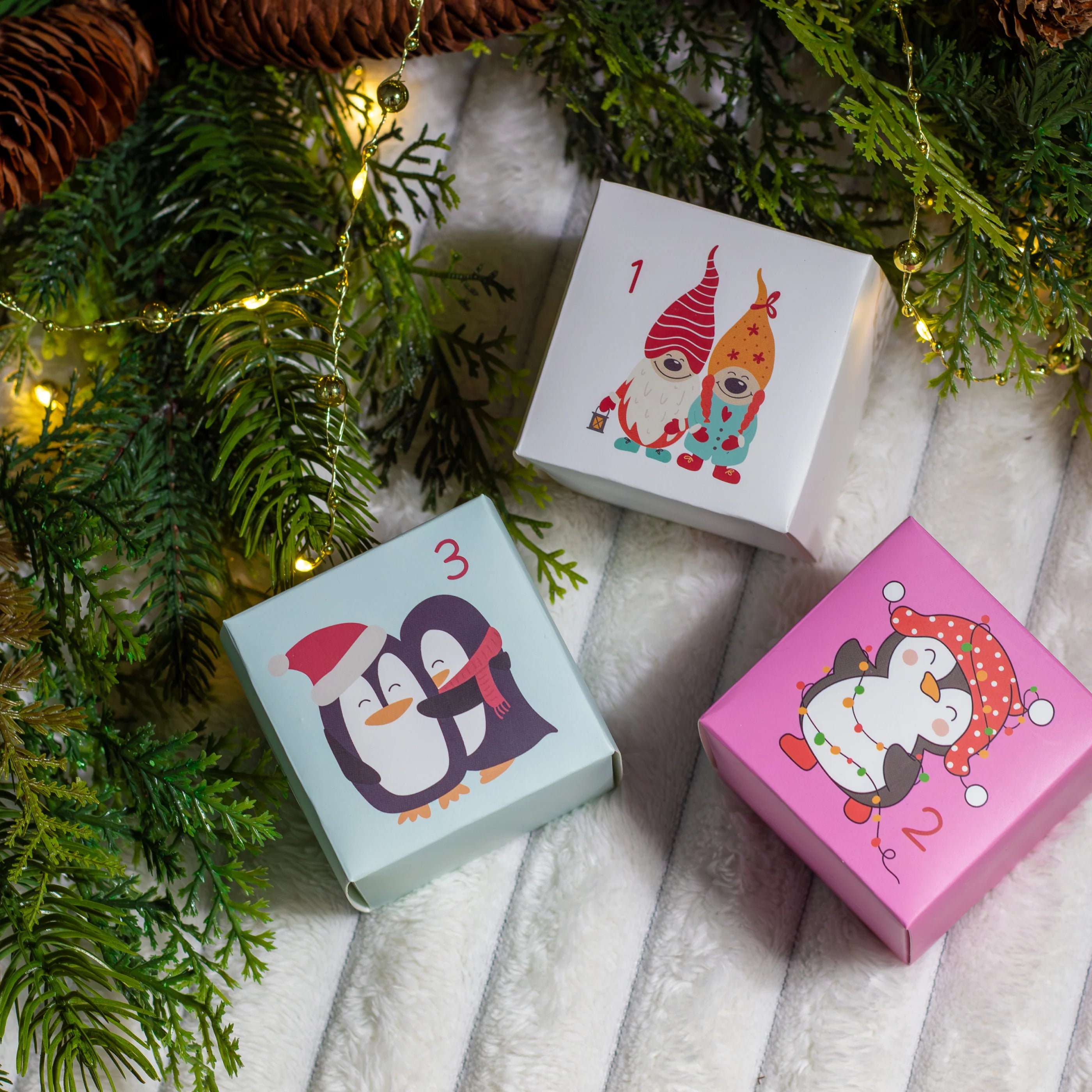 Three small boxes with cartoon characters on a Christmas-themed background