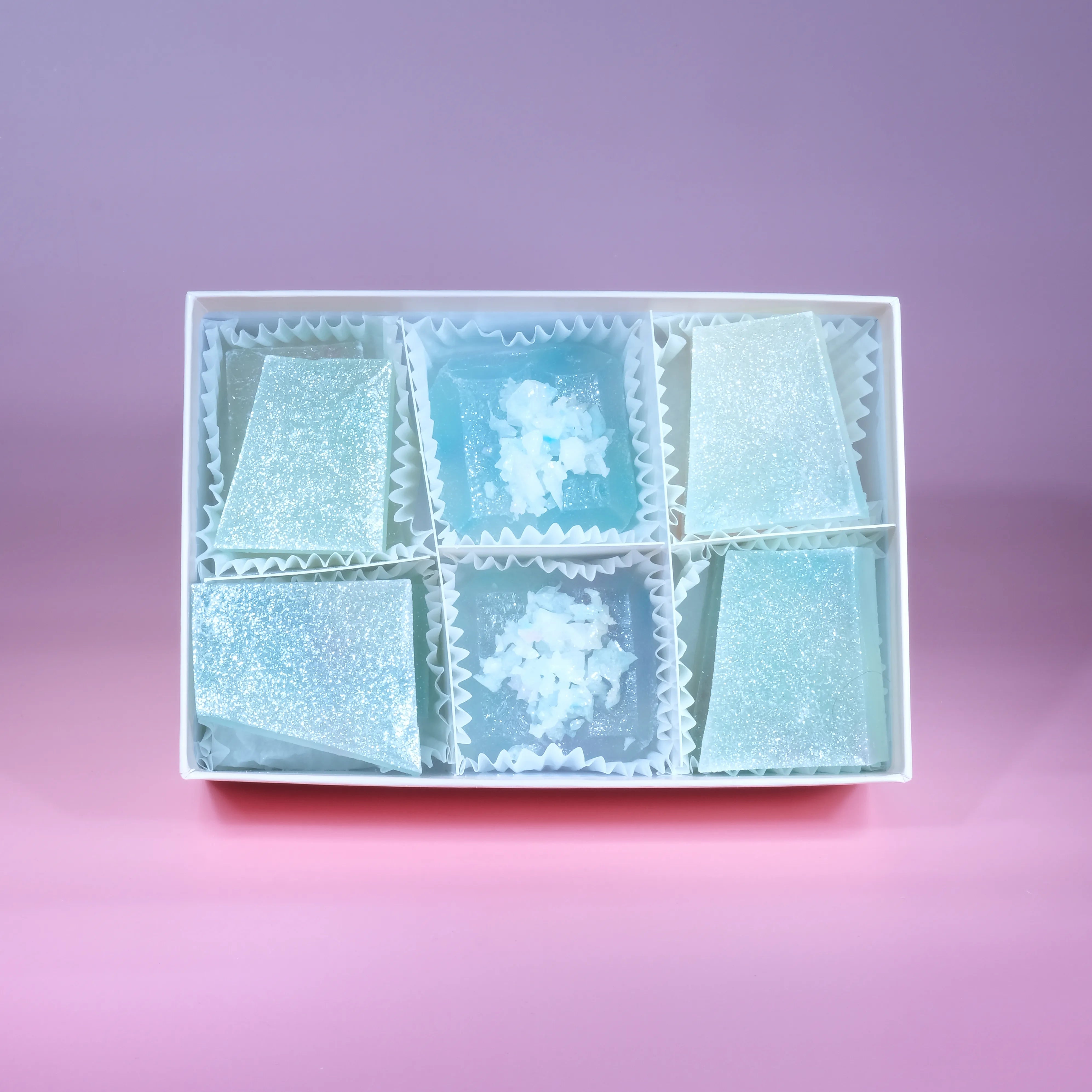 A box of lychee aurora crystal candy with blue and purple hue, almost translucent.