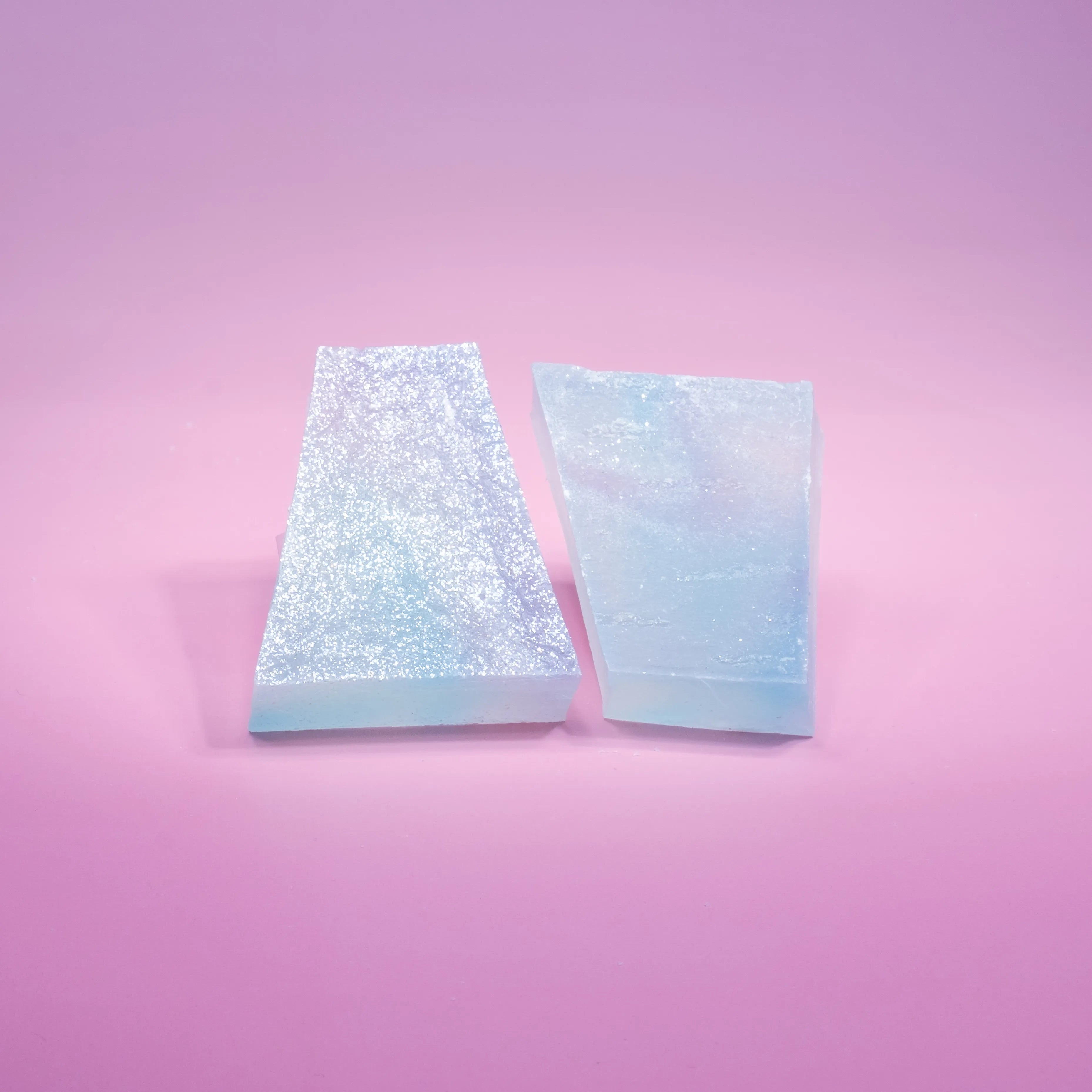 Two lychee aurora crystal candy with blue and purple hue, almost translucent.