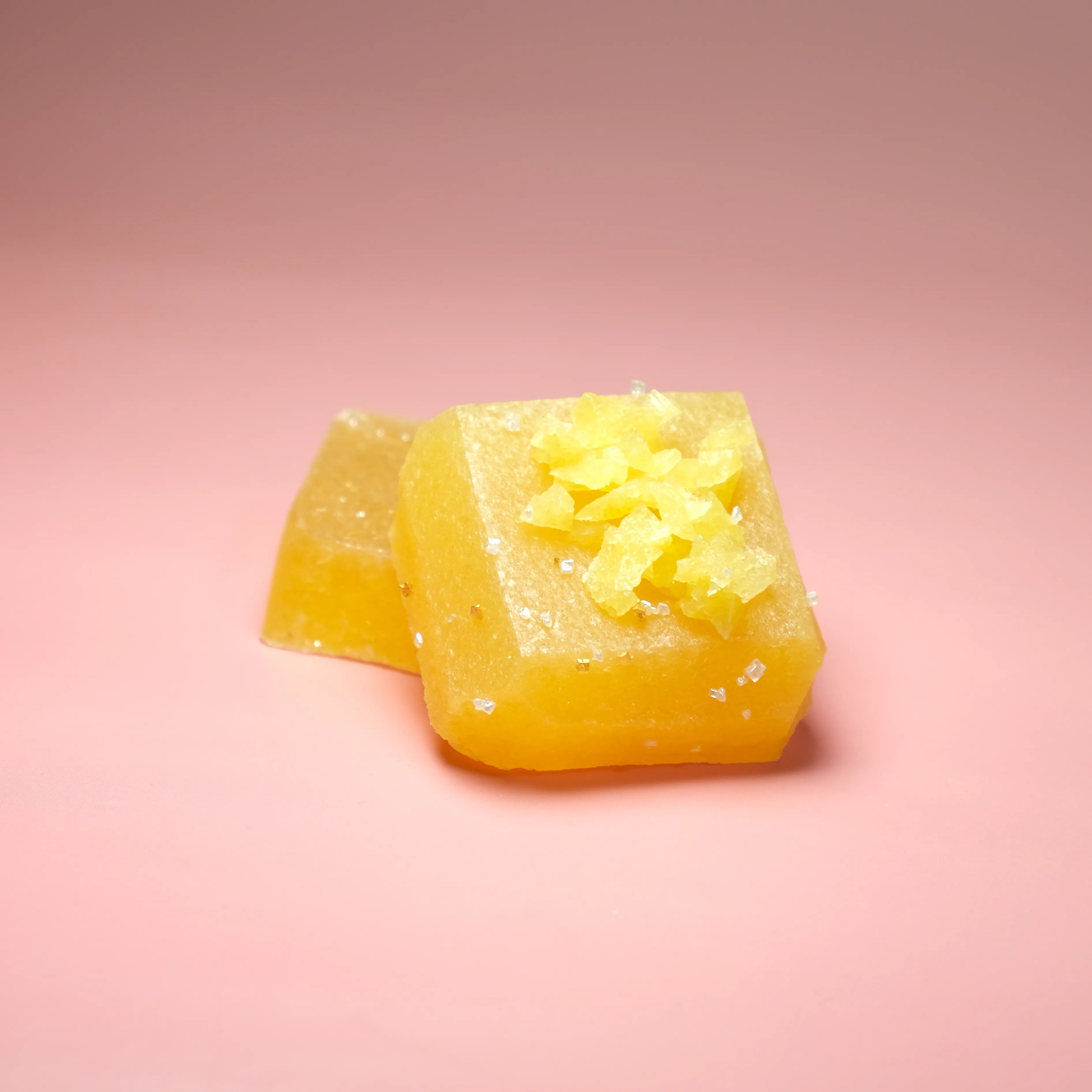 Mango flavored Silky Gem crystal candy with a golden yellow translucent cube and crystallized sugar topping.