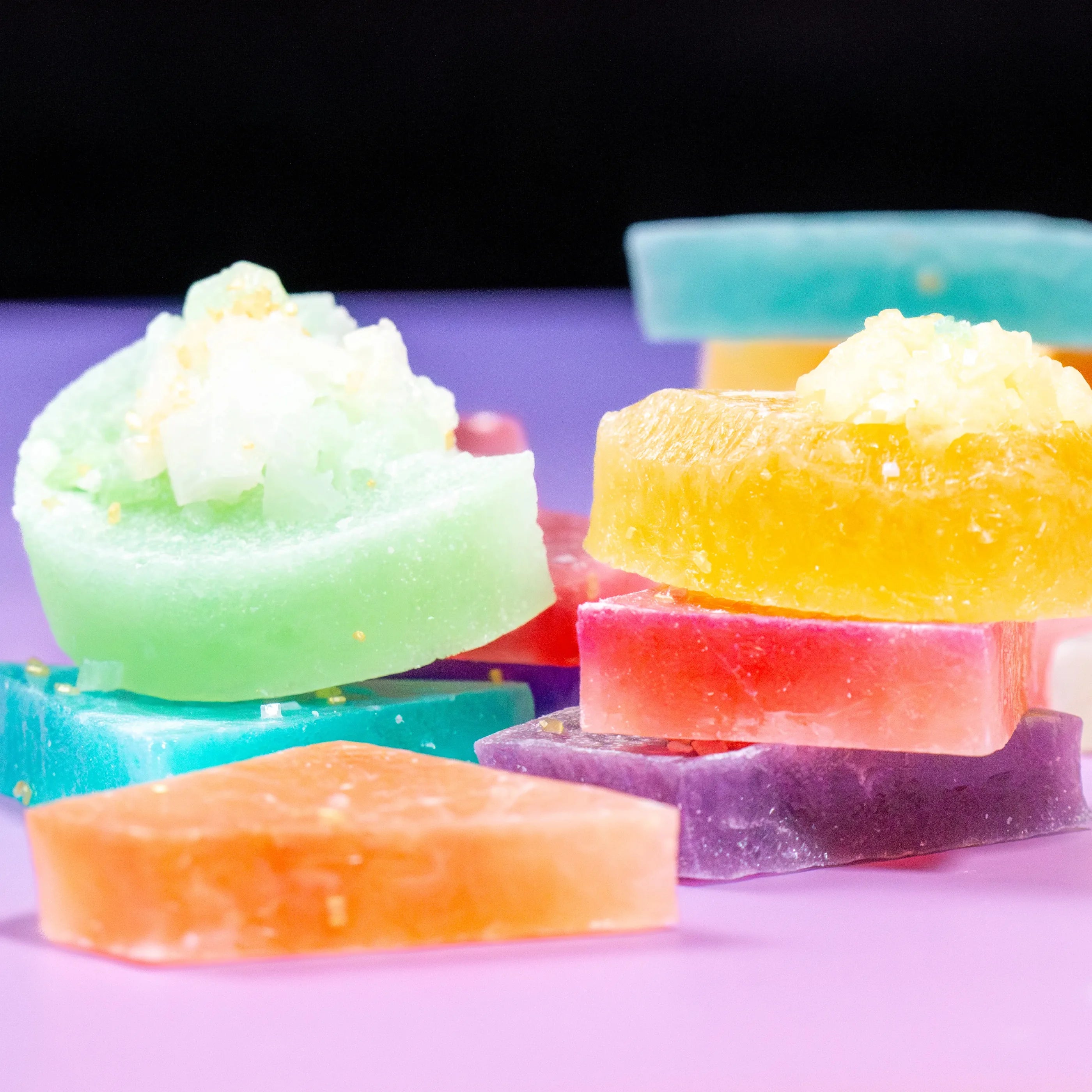 Colorful soap bars on a purple background
