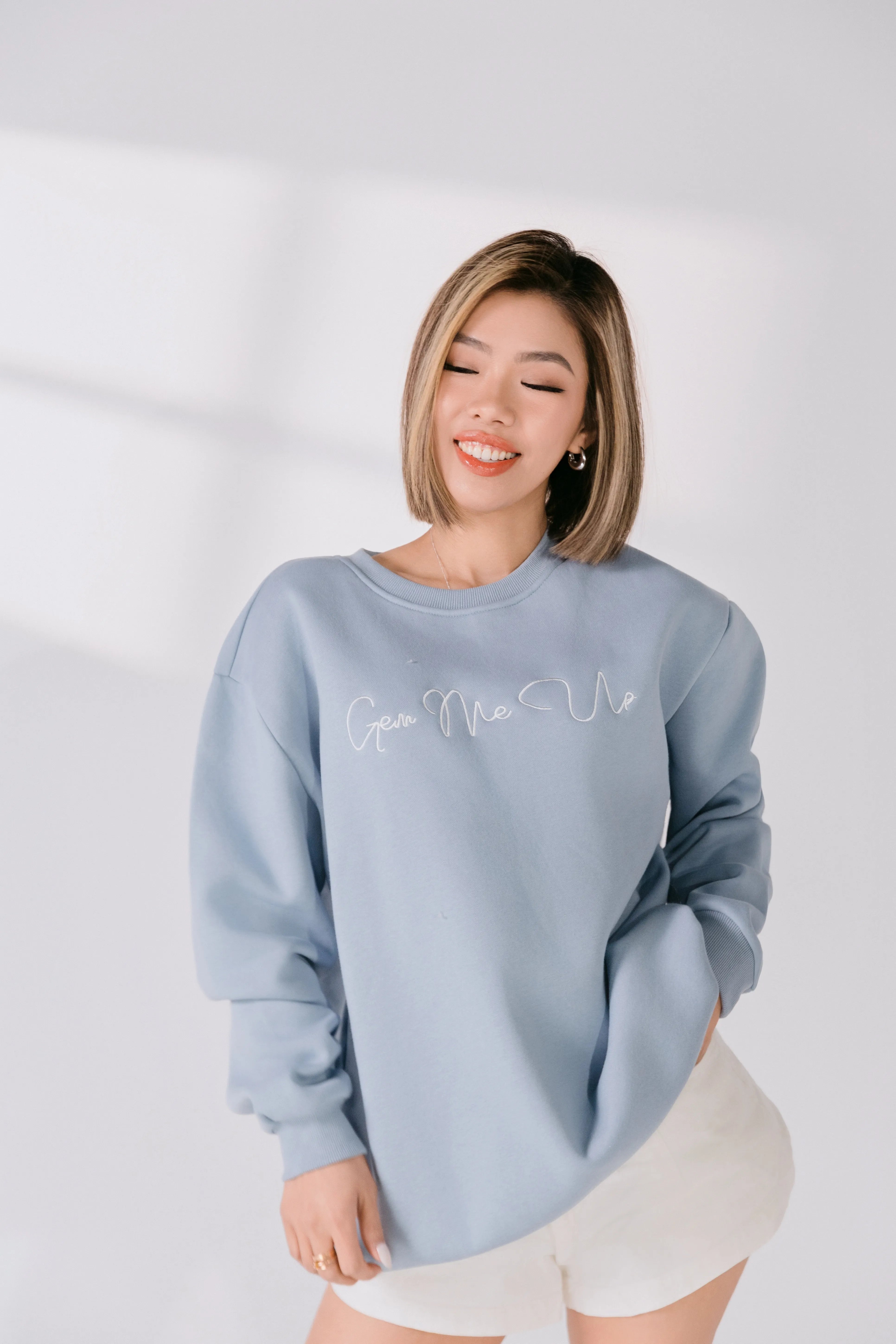 Model wearing powder blue “Gem Me Up” embroidered Silky Gem crewneck.