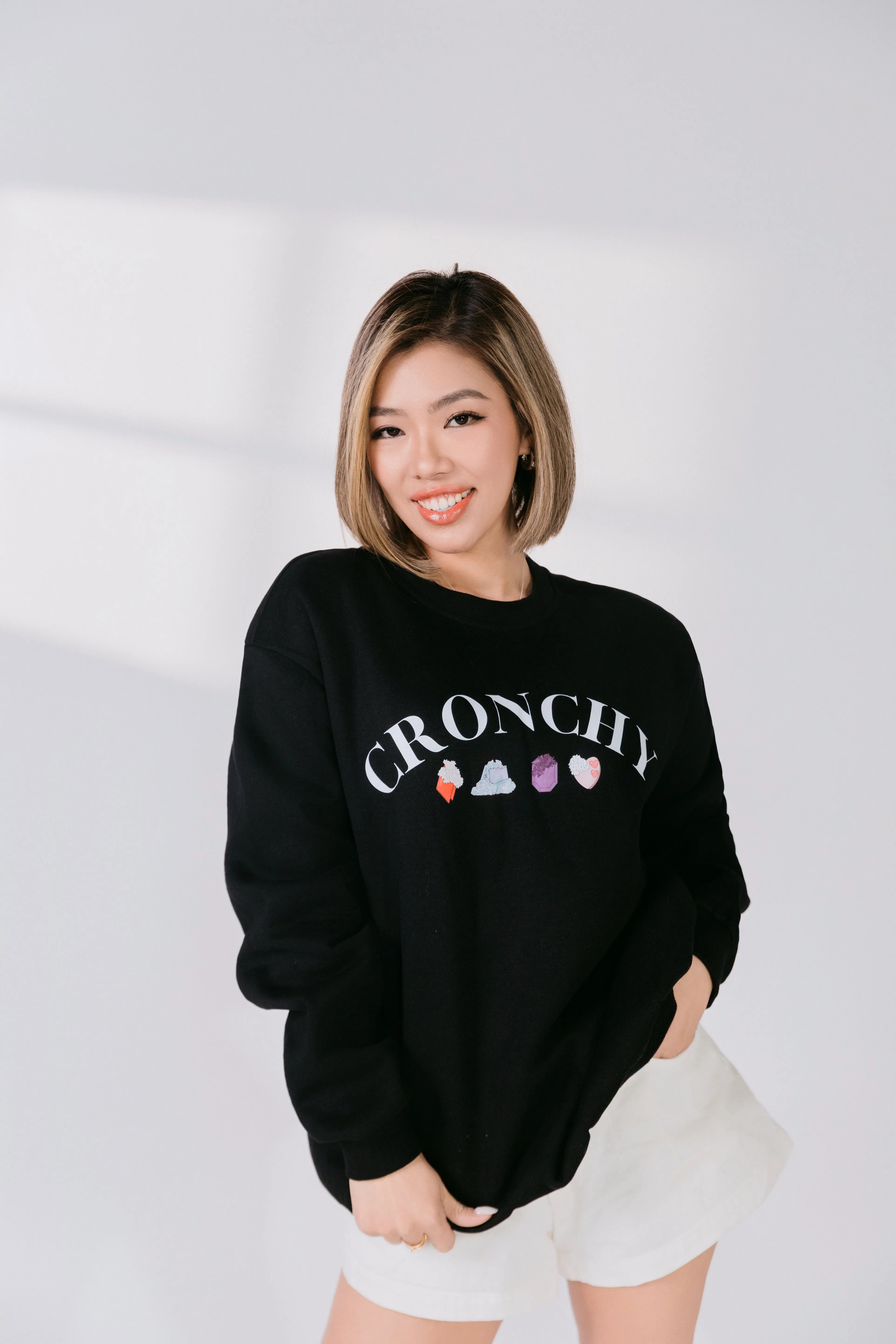 Front view of black sweatshirt featuring crystal candy illustrations.
