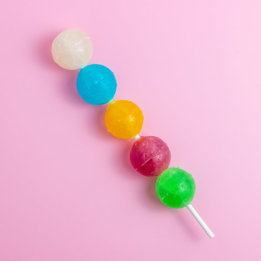 Silky Gem Crystal Pop skewer with five colorful crystal candies on pink background
