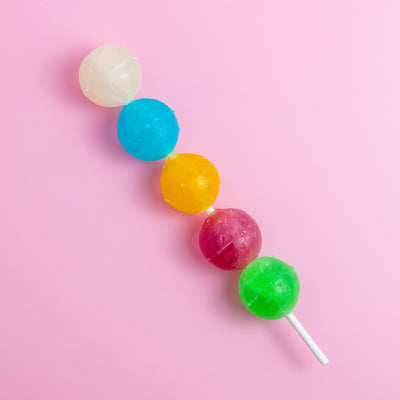 Silky Gem Crystal Pop skewer with five colorful crystal candies on pink background