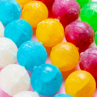 Close-up of Silky Gem Crystal Pop crystal candies on pink background