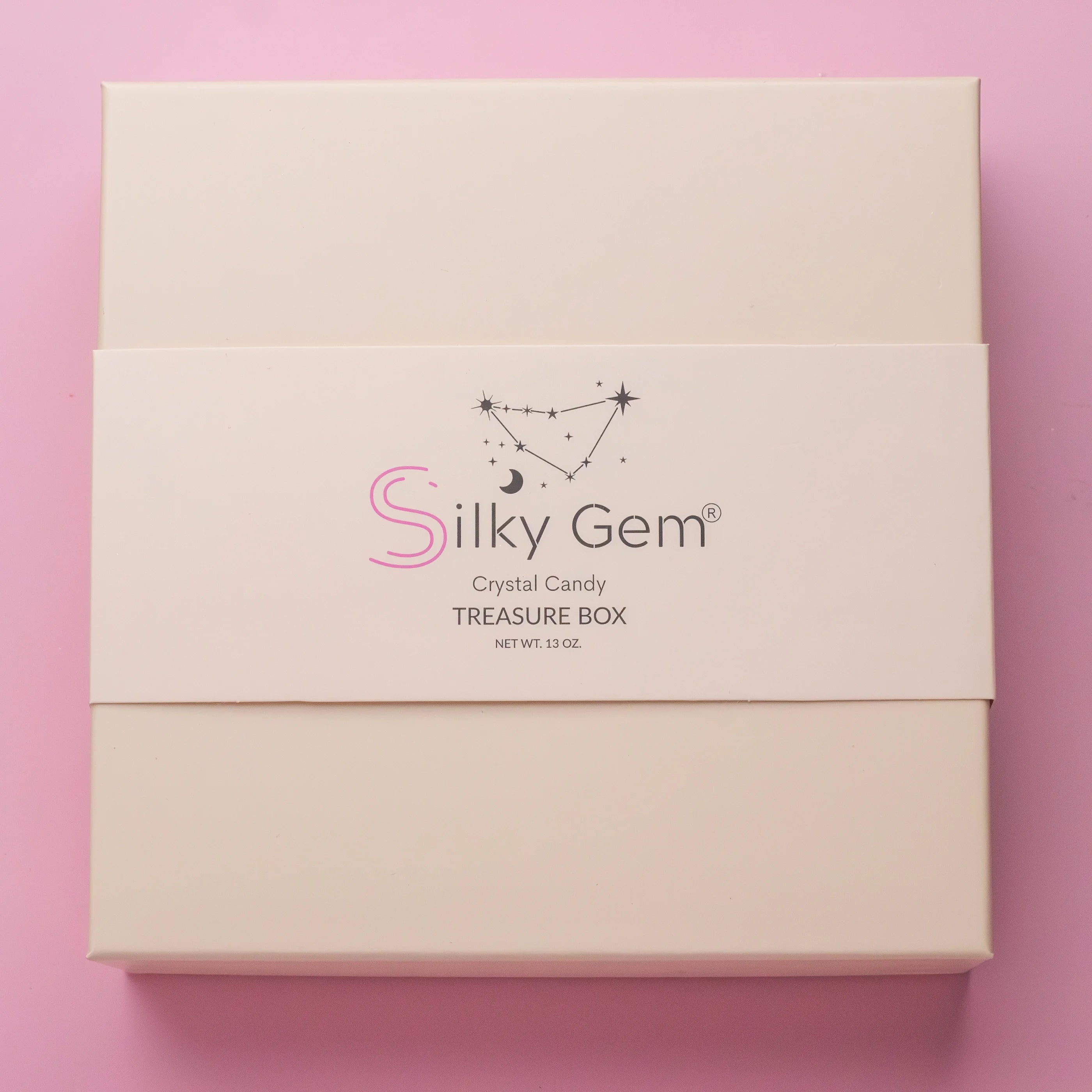 Silky Gem crystal candy treasure box on a pink background