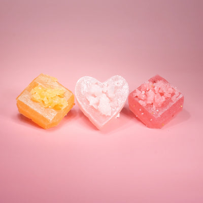 Love at First Bite Trio crystal candies in three colors on a pink background
