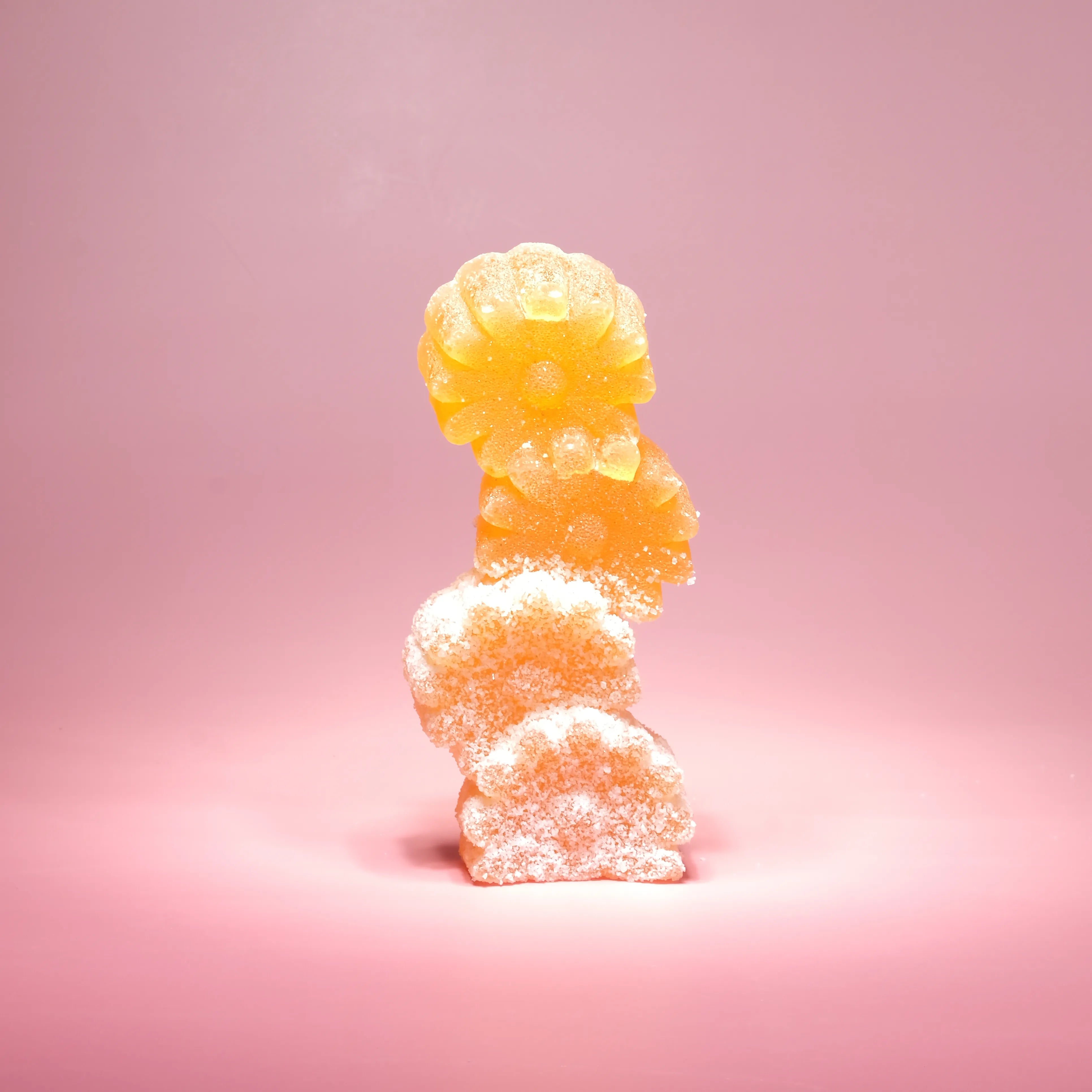 Stack of gummy bears on a pink background