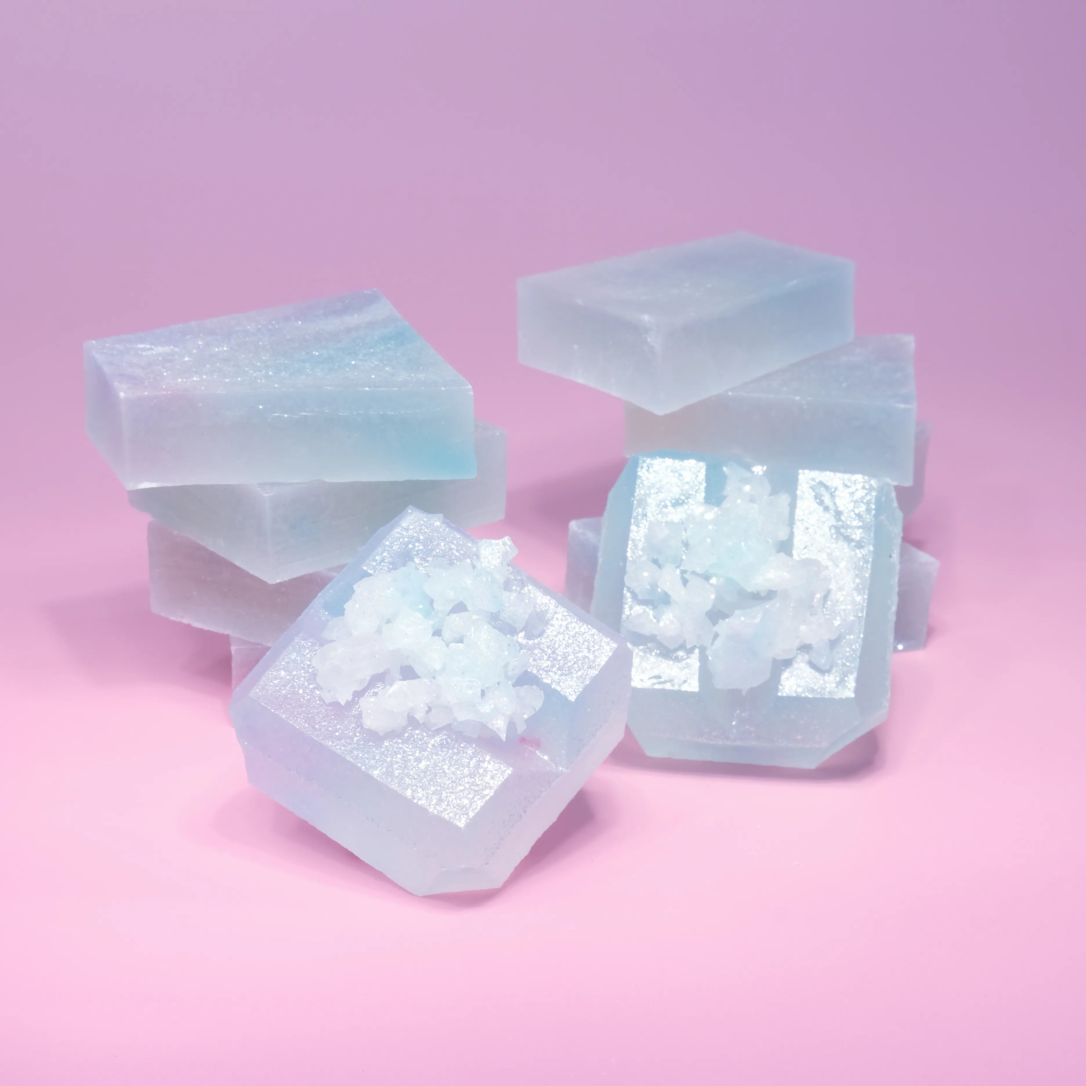 Two stacks of Silky Gem Lychee aurora candy with blue and purple  hue, almost translucent.