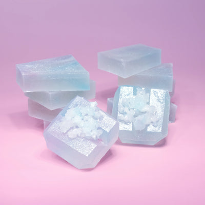 Two stacks of Silky Gem Lychee aurora candy with blue and purple  hue, almost translucent.
