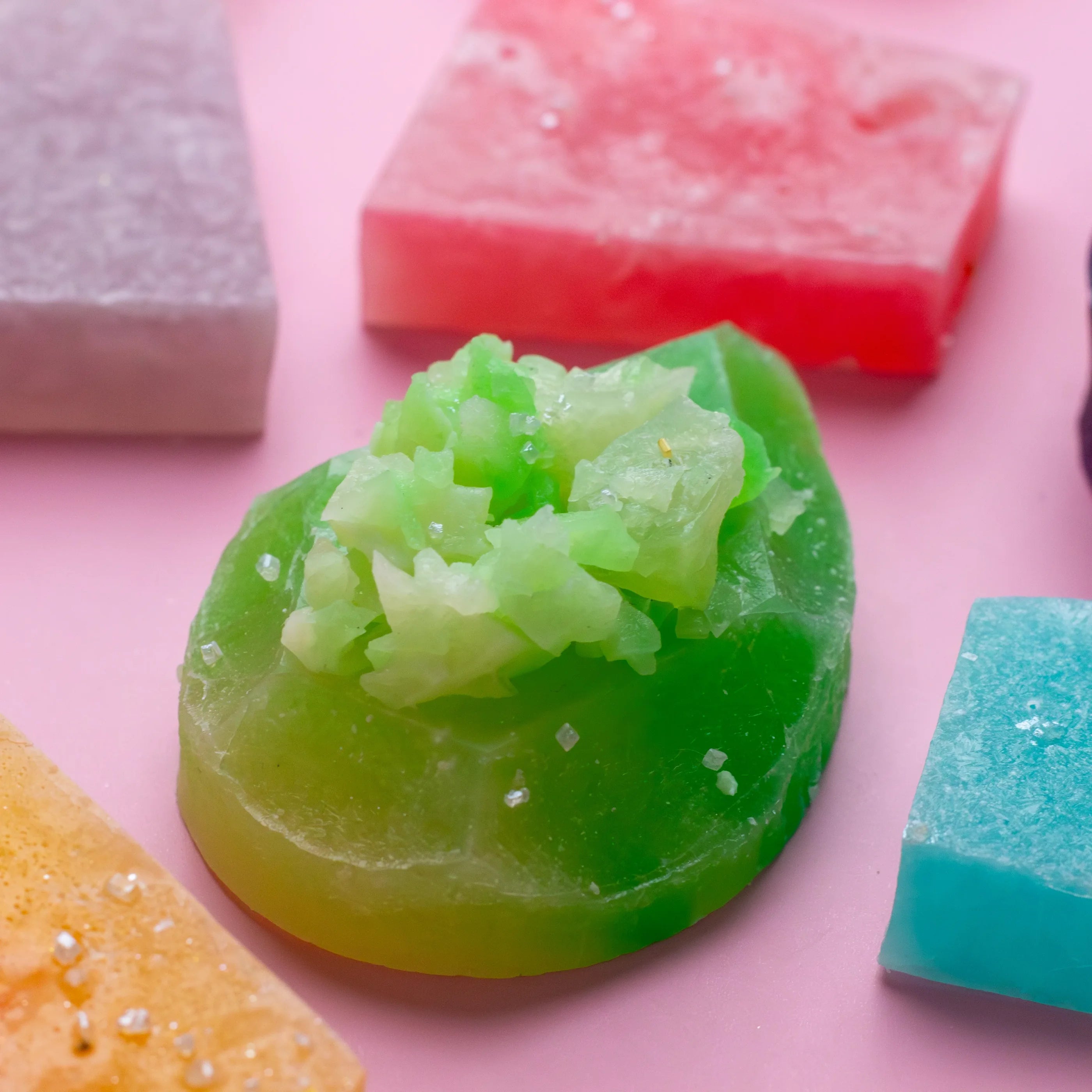 Close-up of colorful soap bars on a pink background