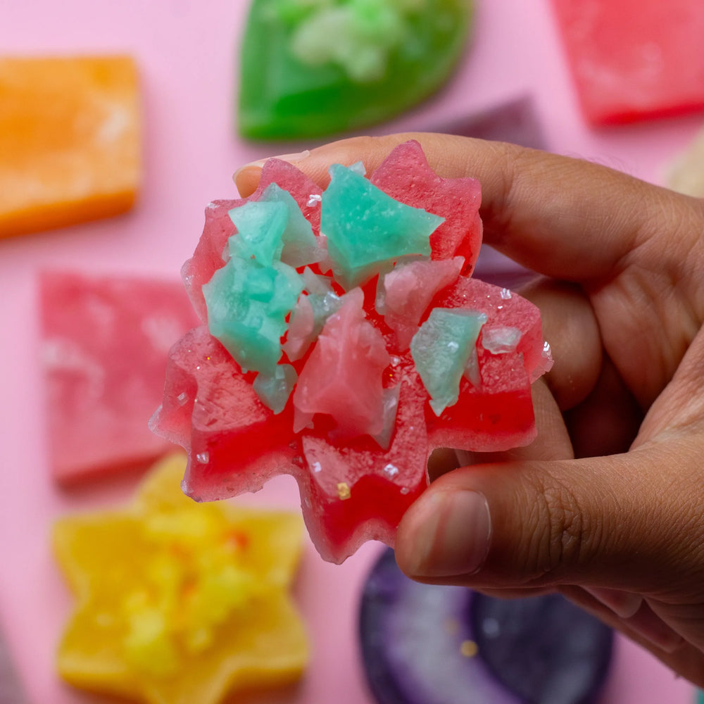 Hand holding a flower-shaped Silky Gem crystal candy from the Mystery Box