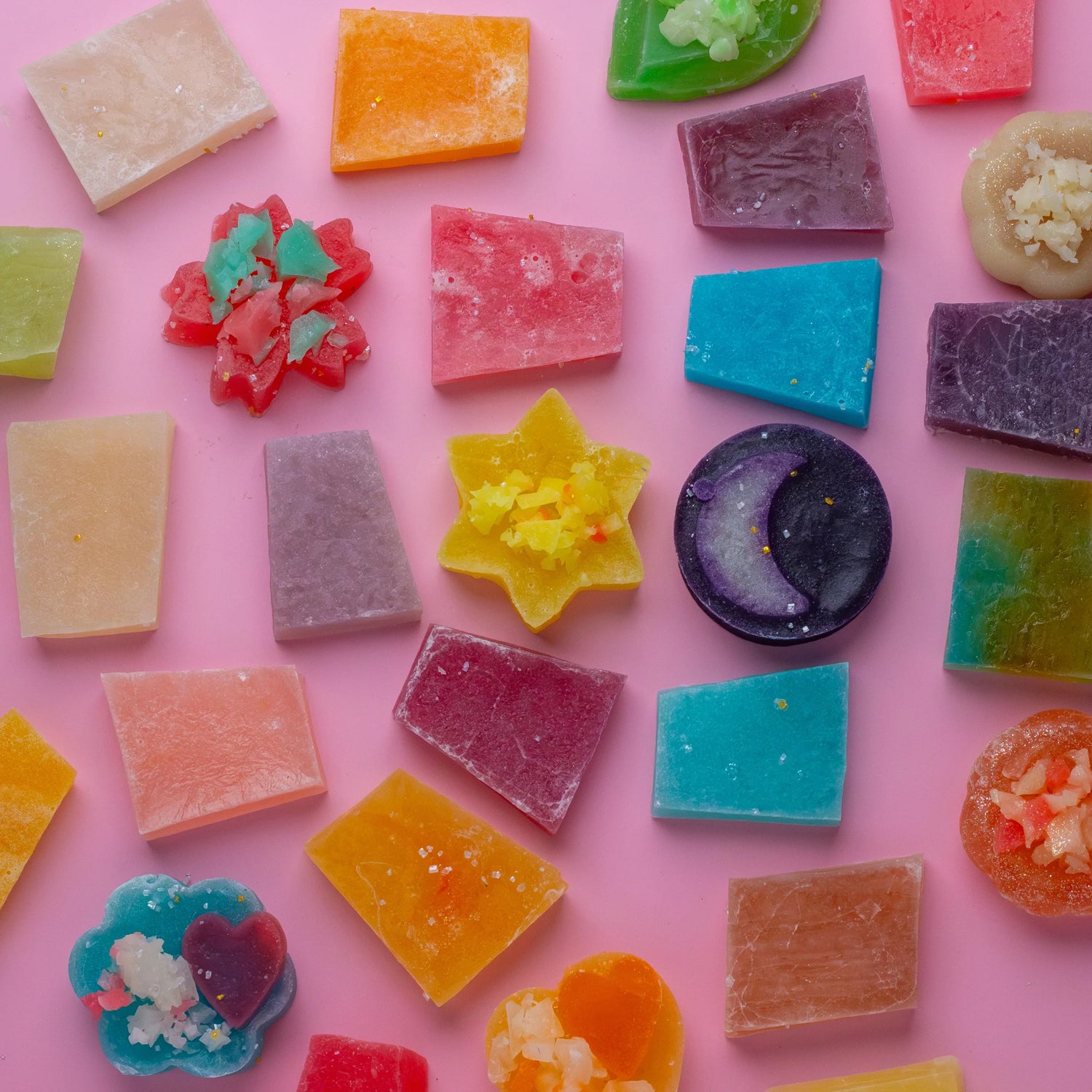 Assorted colorful Silky Gem Mystery Box candies on a pink background