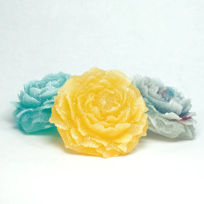 Assorted Peony Dream flower-shaped crystal candies on a light background