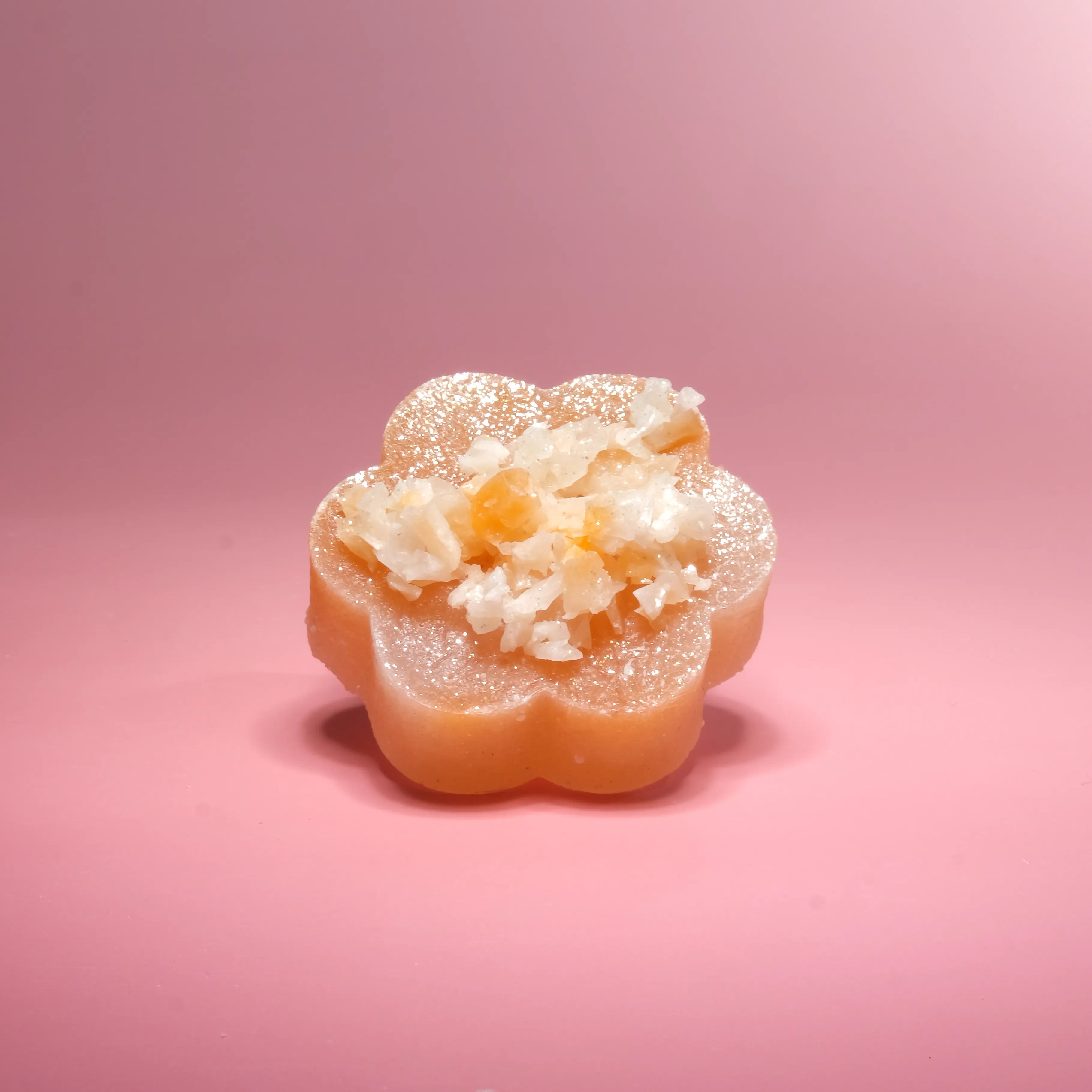 Decorative soap bar with a textured top on a pink background