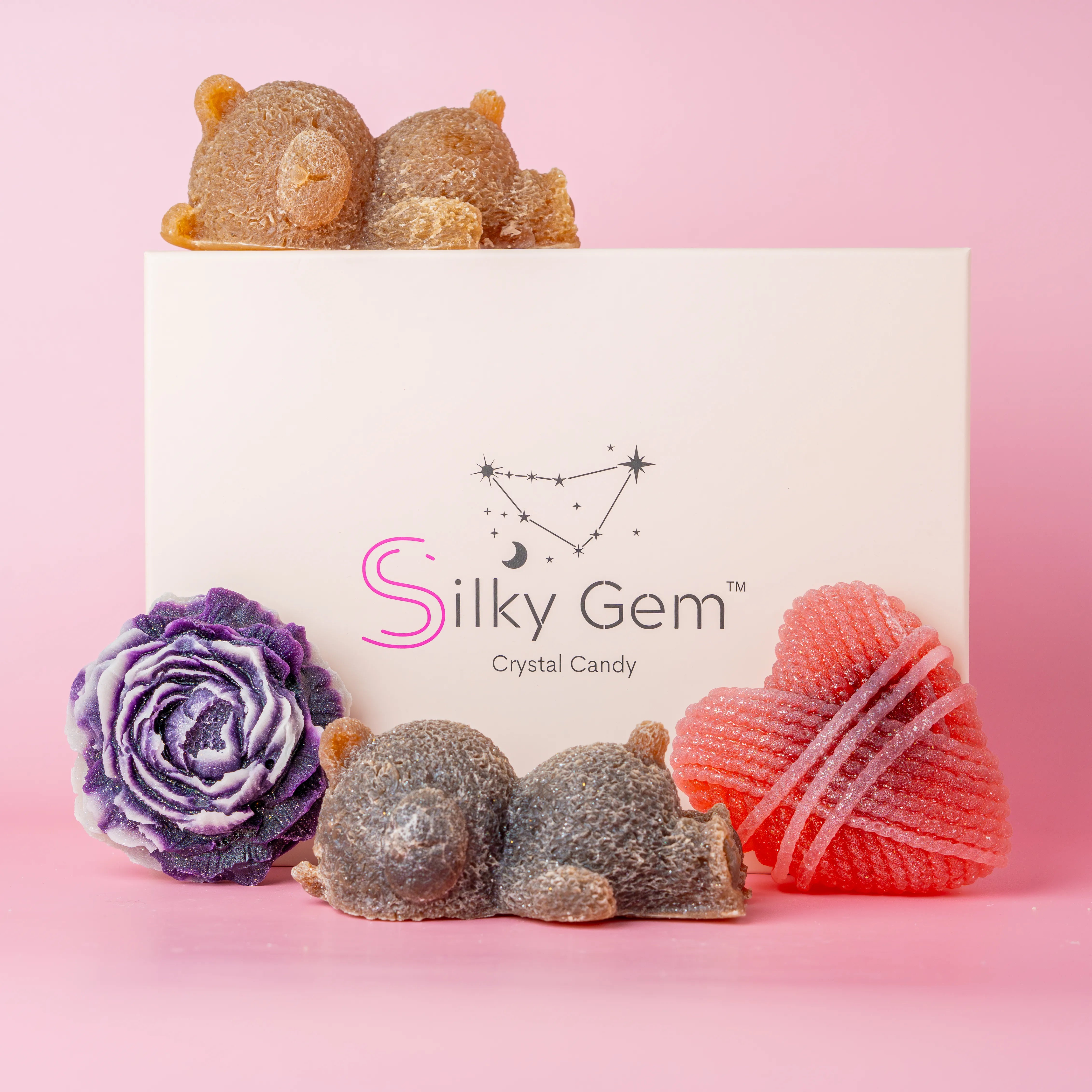 Silky Gem box with a collection of crystal candies. Purple peony, sleeping bears, and heart.