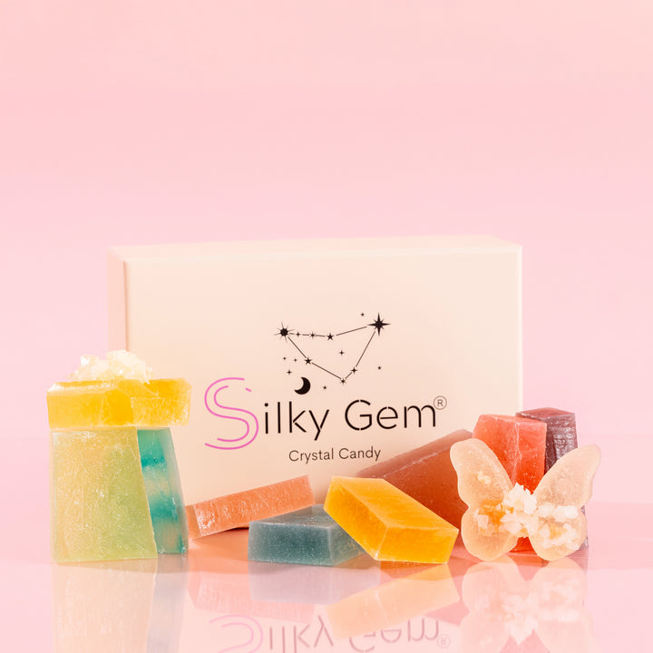 Silky Gem Gemmies Collection featuring 10 handcrafted crystal candy flavors in a branded box on a pink background