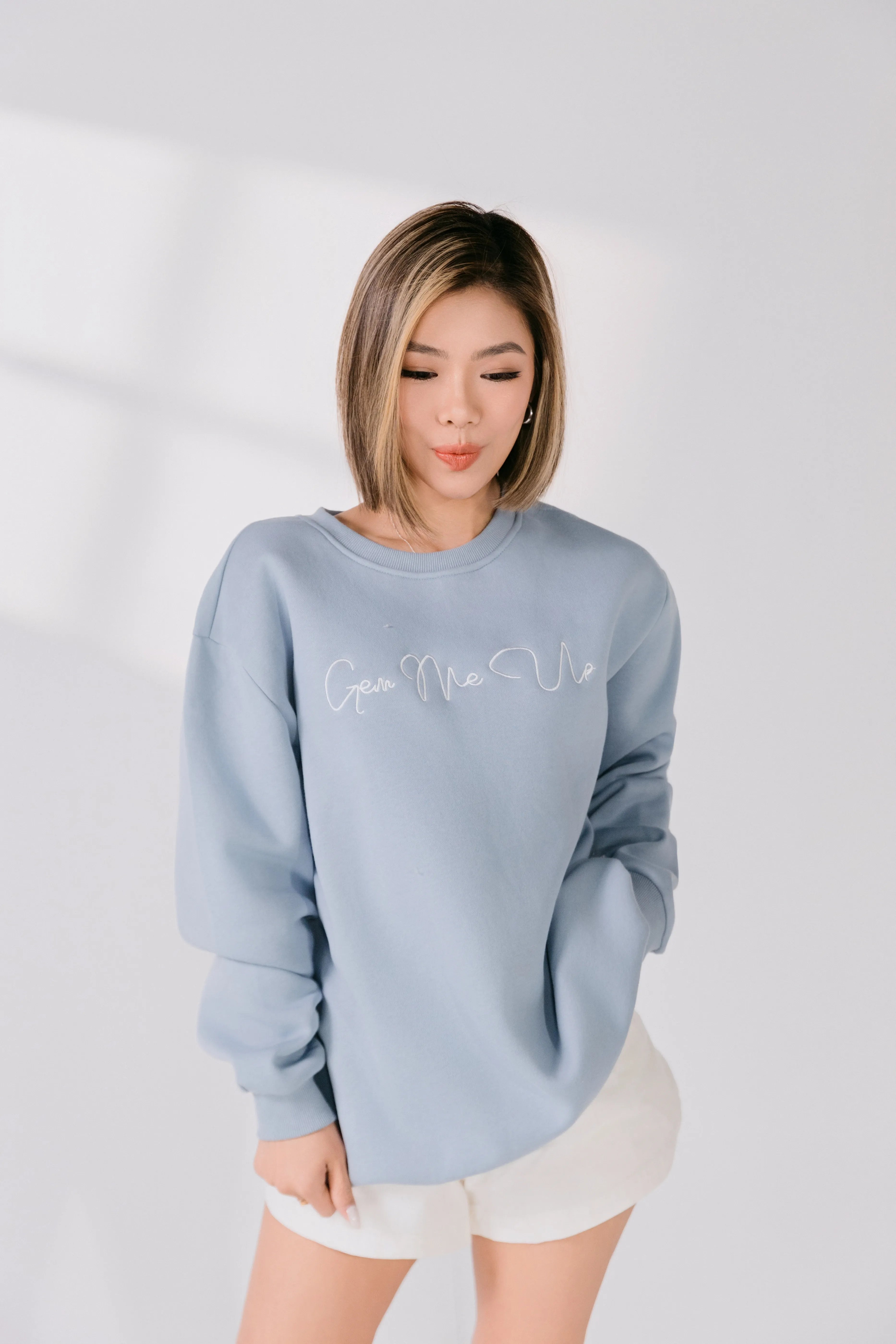 Side angle of powder blue relaxed fit crewneck styled casually