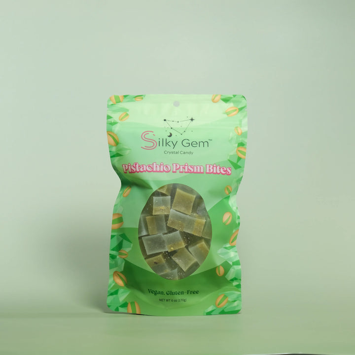 Green package of Silky Gem Pistachio Prism Bites on a light green background